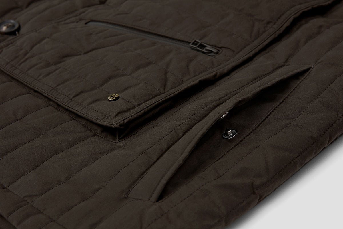 Deep hand-warmer pockets are fastened with a pop-stud.
