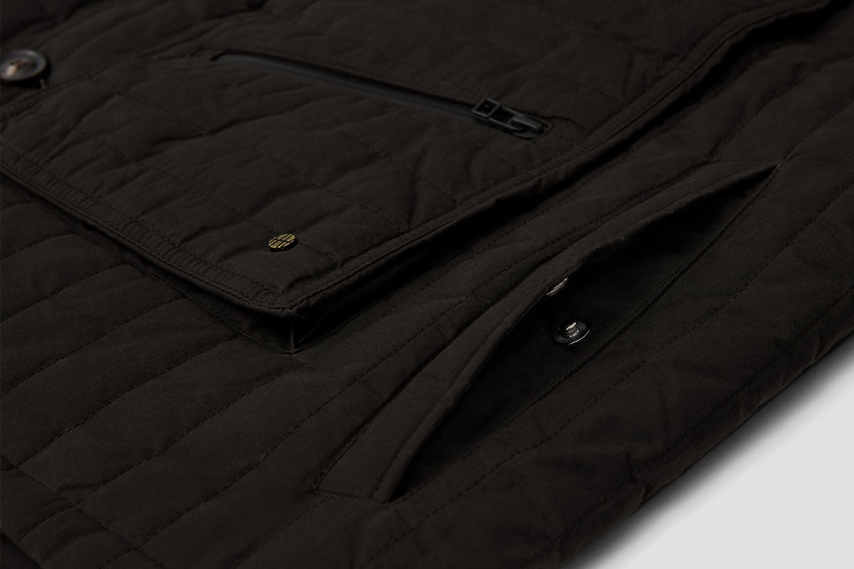 Deep hand-warmer pockets are fastened with a pop-stud.